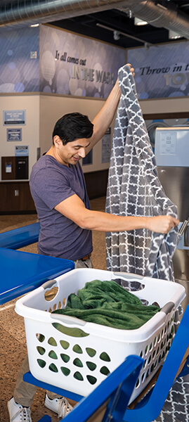 a man folding a clean blanket